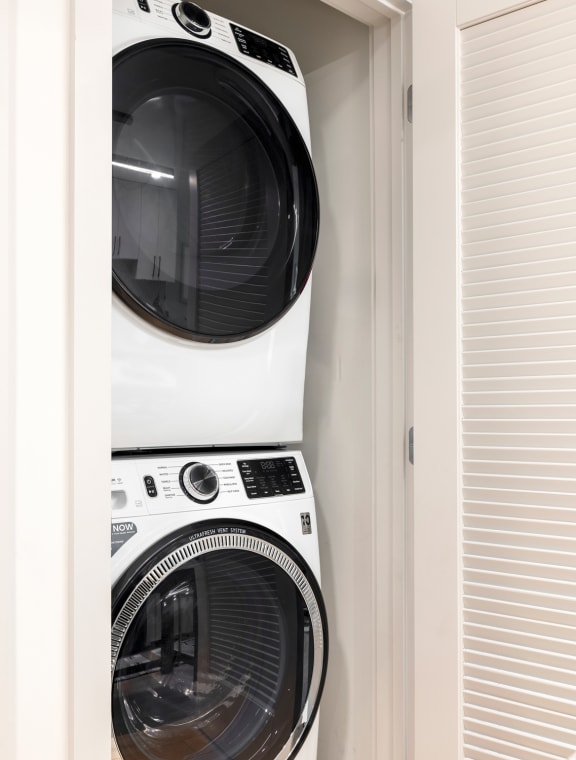 a white washer and dryer in a closet