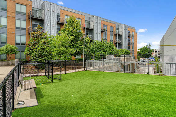 A grassy area in front of apartment buildings.