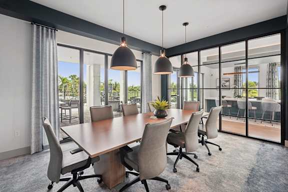 A conference room with a long table and chairs.