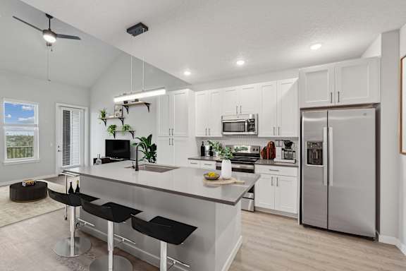 Staged A3 floor plan showing kitchen with stainless steel appliances at The Crossing at Palm Aire