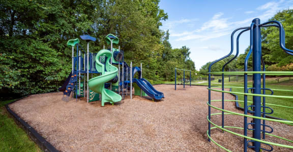 a playground with a slide and monkey bars