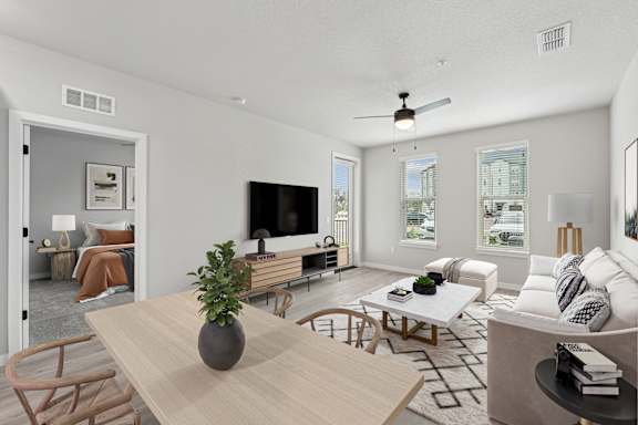 A modern living room with a wooden table and chairs.