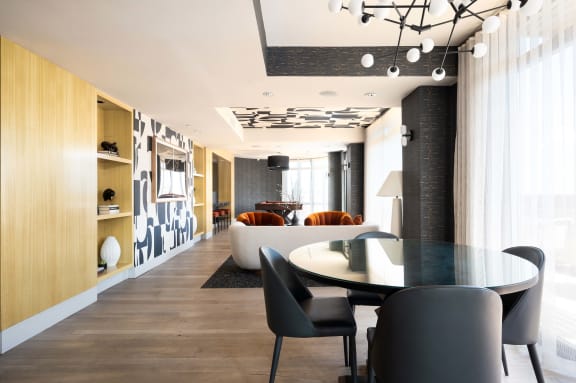 a dining room and living room with a table and chairs
