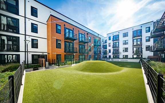 modern apartment buildings with a lawn in the middle