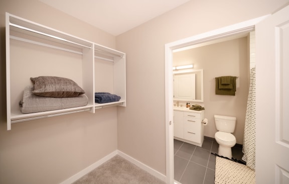 Walk-in closet leading to bathroom