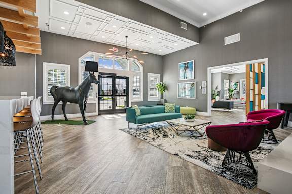 A living room with a giraffe statue in the middle.