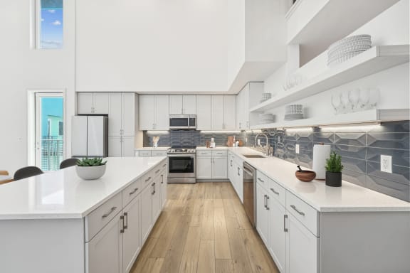 a large kitchen with white cabinets and white counter tops