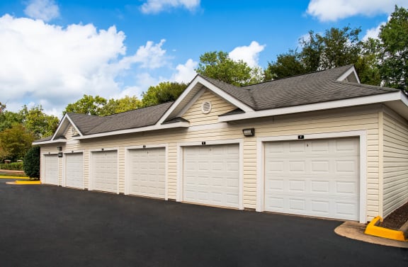 a row of white garage doors on the side of a building