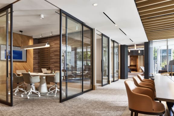 a conference room with glass walls and a table with chairs