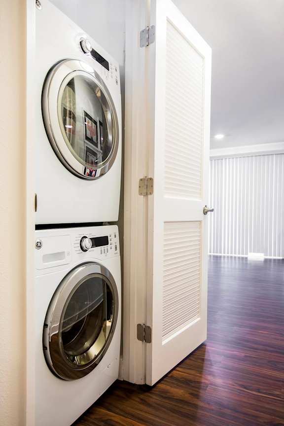 A white washing machine and dryer in a laundry room.