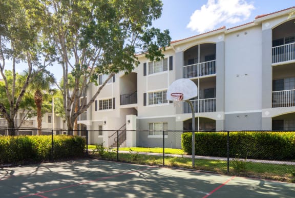an apartment building with a basketball hoop in front of it