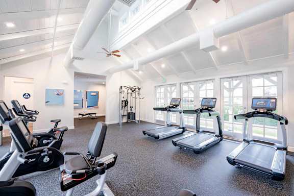 A gym with treadmills and exercise bikes.