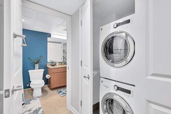 A white washing machine is in a doorway.