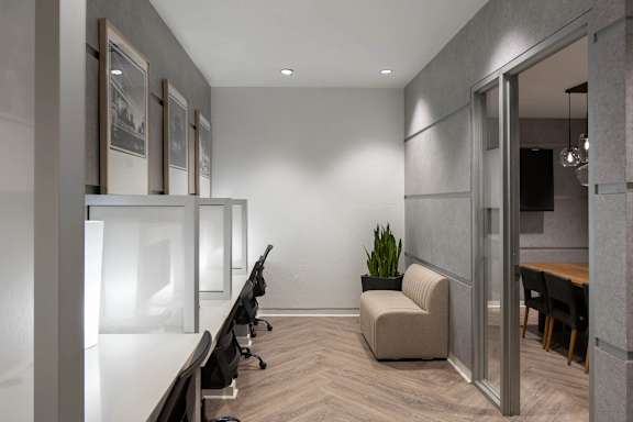 A modern office space with a row of chairs and a couch.