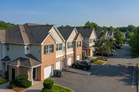 a row of houses with a car parked in a parking lot