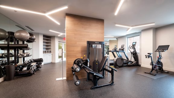 a gym with various machines and weights on the floor
