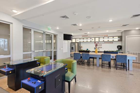 A room with a pool table and a bar area.