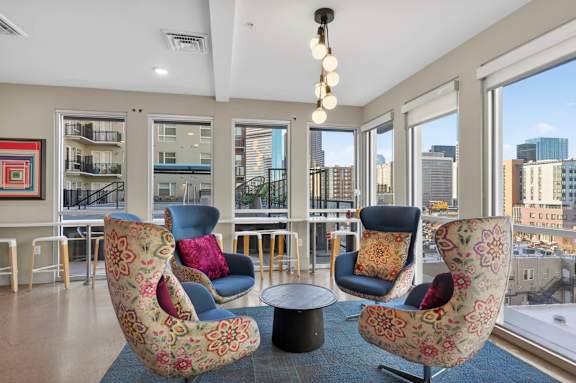 Modern indoor lounge with seating, game tables, and open common area.