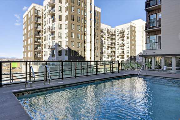 Outdoor pool with surrounding deck and seating.