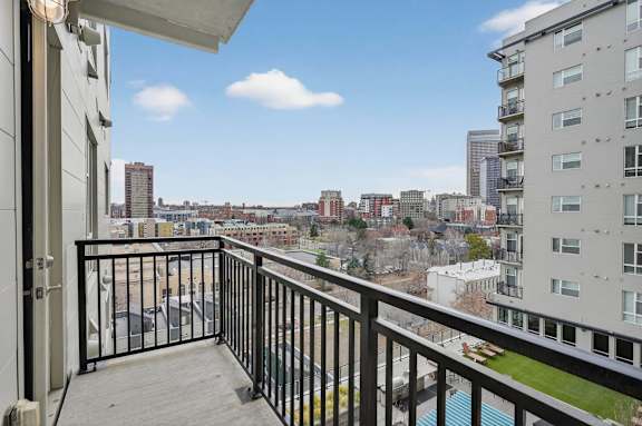 Apartment balcony with city skyline views.