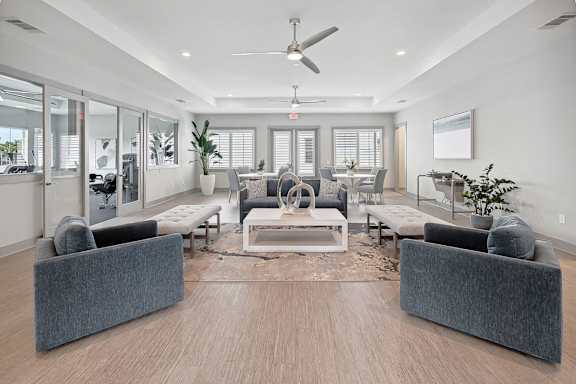 A modern living room with a grey sofa set and a wooden floor.