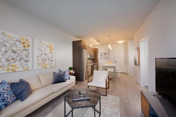 A living room with a white couch and a coffee table.