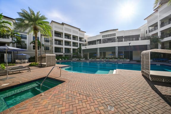 a large swimming pool with buildings in the background
