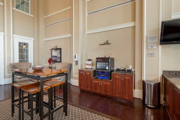 A kitchen with a table and chairs in the middle of the room.