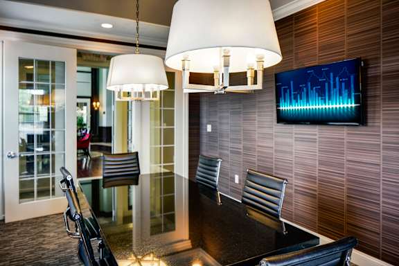 A modern dining room with a glass table and chairs.