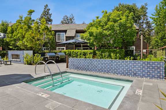 A pool with a slide in the middle of it.
