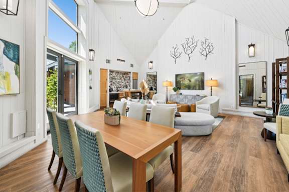 A dining room with a wooden table and chairs.