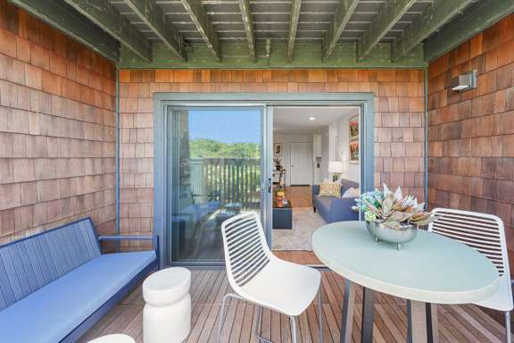 A patio with a table and chairs.