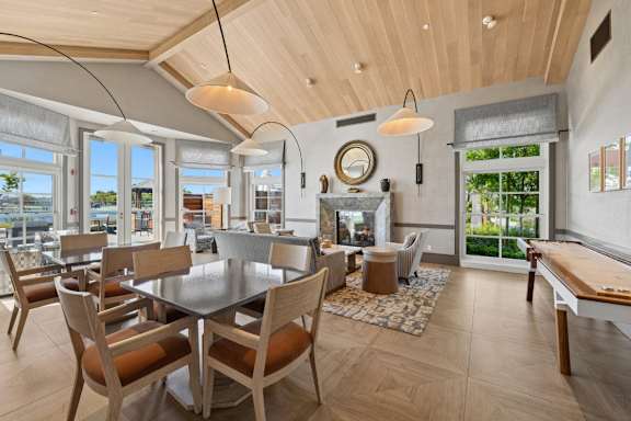 A modern dining room with a large table and chairs.