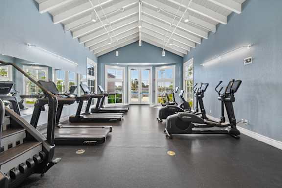A gym with treadmills and elliptical machines.