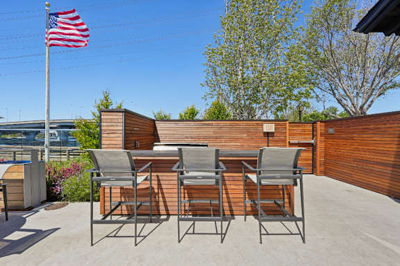 A patio with chairs and an American flag.