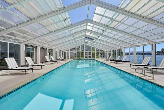 A long rectangular swimming pool with a glass ceiling.