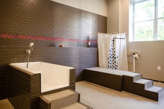 A bathroom with a shower and a bathtub.