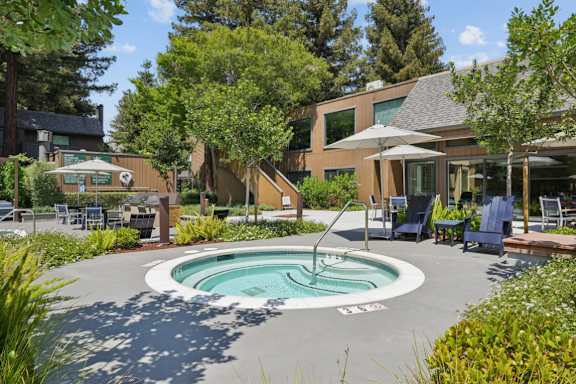 A round pool in the middle of a grassy area.