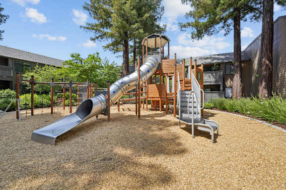 A playground with a slide and a wooden structure.