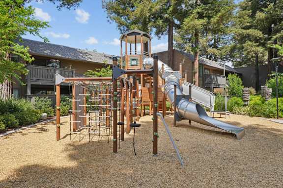 A playground with a slide, swings, and a climbing structure.