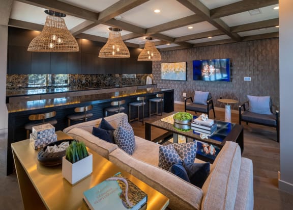 a living room with a kitchen and a table with chairs