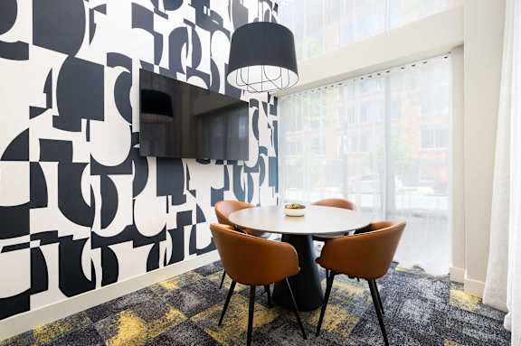 a dining room with a table and chairs and a television