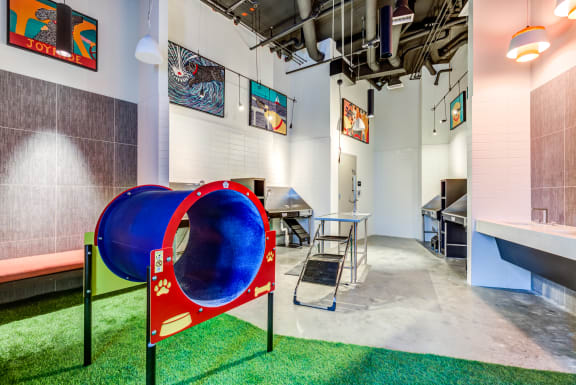 a play area with a seesaw in a room with a table and chairs