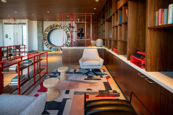 a living room with a chair and a rug