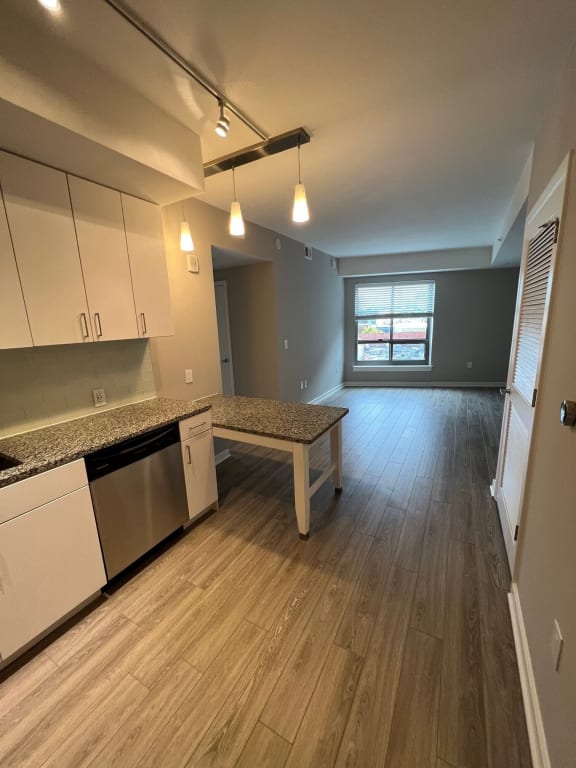a kitchen and living room in an empty apartment