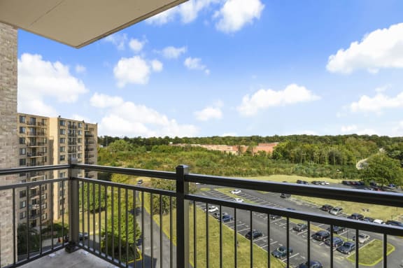 a balcony with a view of a parking lot