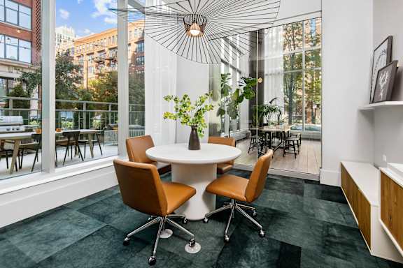 A modern conference room with a round table and chairs.