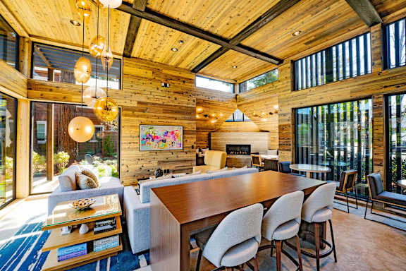 A modern dining room with a wooden table and chairs.
