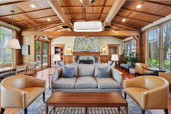 A living room with a couch, chairs, and a coffee table.