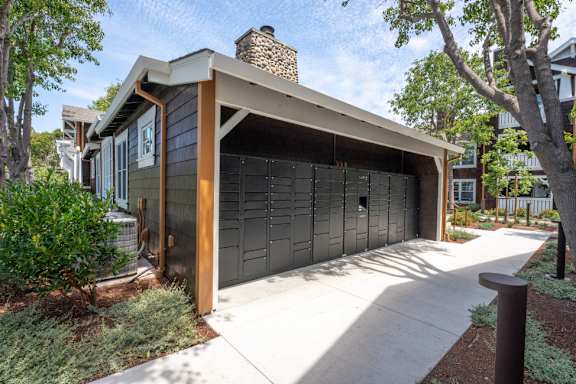 A modern house with a garage door and a chimney.